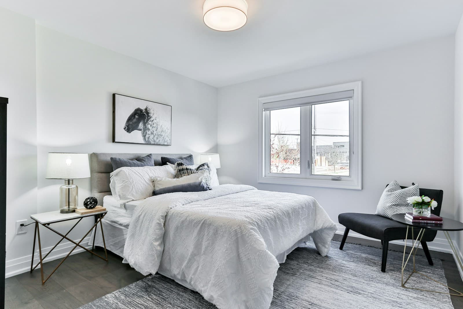 Calm bedroom with a framed picture and chair